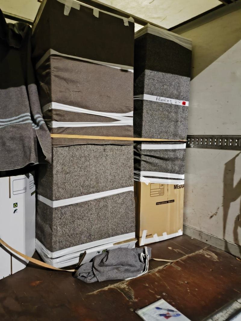 Muebles envueltos en mantas y sujetos con cinchas dentro del camión